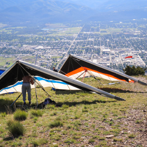 hang gliders at launch site above city