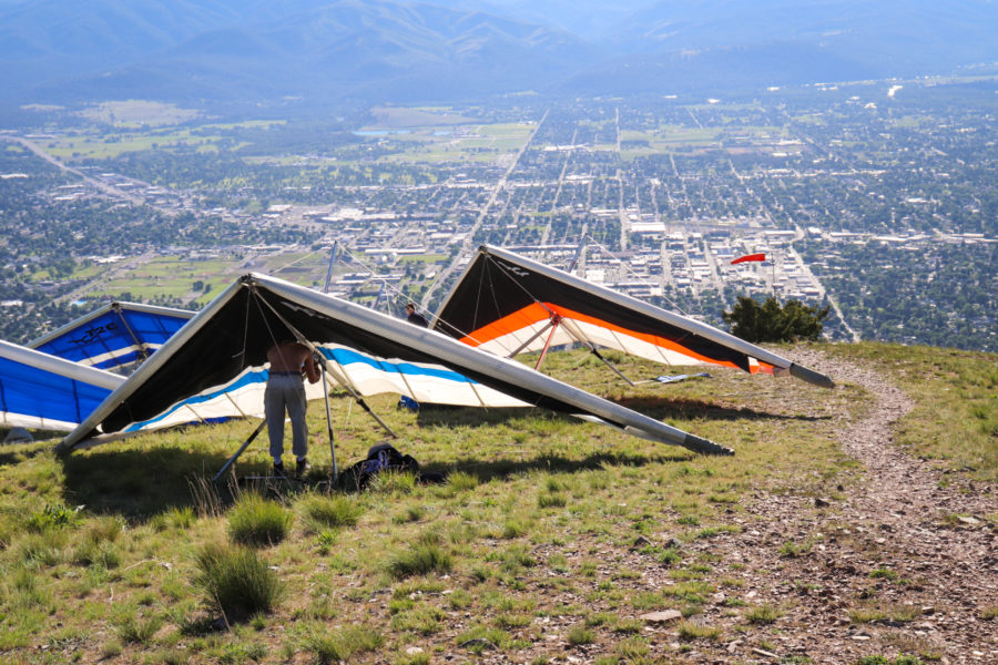 hang gliders at launch site above city